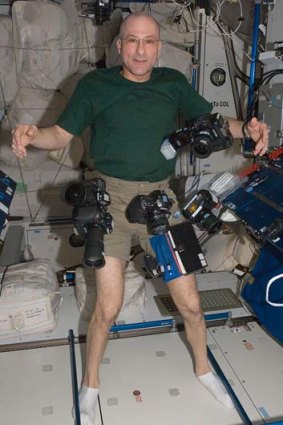 Astronaut Don Pettit with his camera gear aboard the International Space Station.