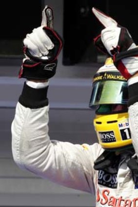 Lewis Hamilton signals to the crowd after winning the Hungarian F1 Grand Prix in style.