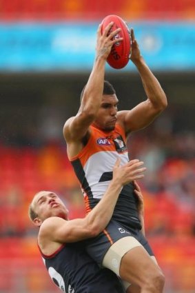 One Giant leap: Curtly Hampton soars above Melbourne's Dean Terlich.