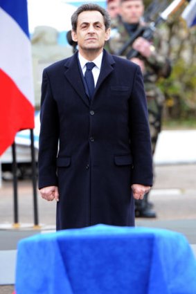 French President Nicolas Sarkozy pays his respect in front of the coffin of one of three French paratroopers killed in Montauban.