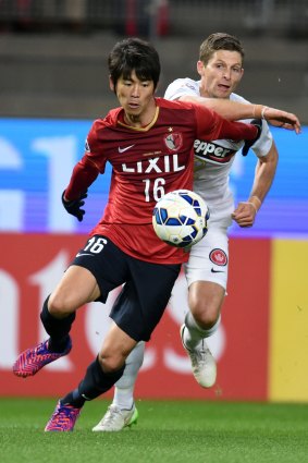 Shuto Yamamoto of Kashima Antlers gets to the ball ahead of Shannon Cole.