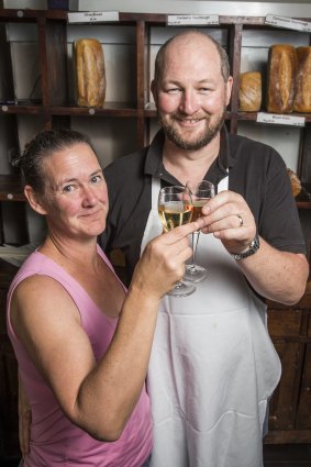 Paul Clowry and Trilby Rippon toast to the end of an era for the Cornucopia Bakery that shuts its doors on Christmas Eve after 30 years in Braddon.