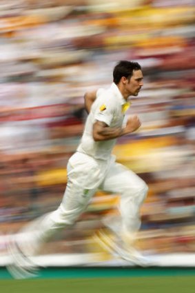 On the run: Mitchell Johnson tears in at the Gabba.