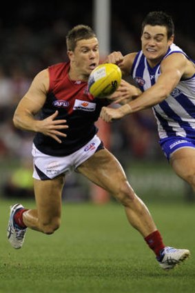 Brent Maloney of the Demons contests with Nathan Grima of the Kangaroos last year.