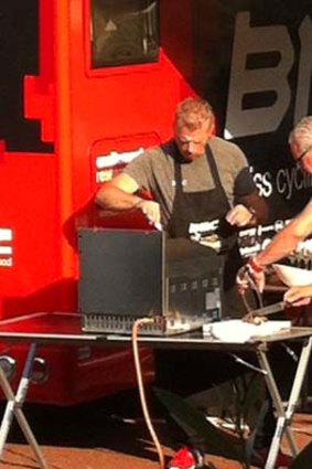 Peter Cambre fires up the grill for BMC staff 12 hours after extinguishing a fire that could have damaged Cadel Evans's tour hopes