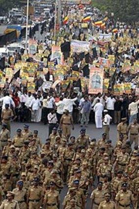 Kinship pangs ... police escort protestors holding portraits of the Tamil Tigers' slain leader Prabhakaran in the Indian city of Chennai.