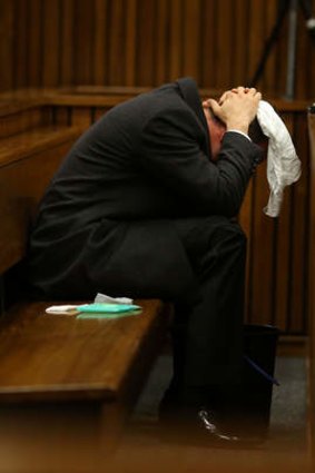 Sick to his stomach ... Olympic track star Oscar Pistorius vomits into a bucket on the sixth day of his murder trial.
