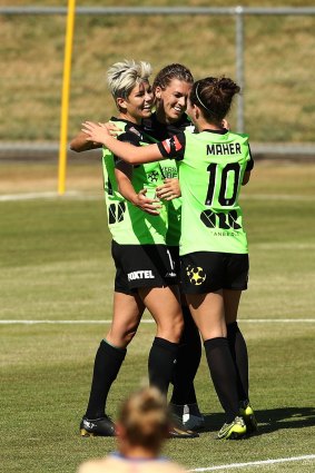 Michelle Heyman  celebrates with Canberra United teammates after scoring a goal.