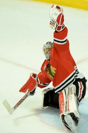 Chicago goalie Corey Crawford pulls off one of his 51 saves.