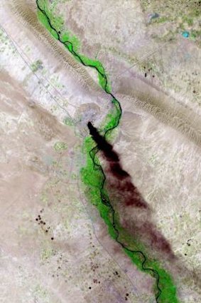 A satellite picture from the US Geological Survey dated June 18 shows smoke rising from the Baiji refinery near the Iraqi city of Tikrit, a focus of fighting between Sunni militants and government forces.