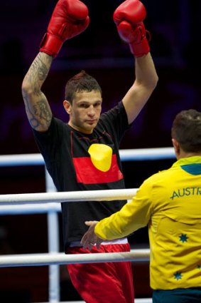 Damien Hooper (L) of Australia wears a T-shirt featuring the Aboriginal flag as he arrives for his first round light-heavyweight (81kg) match, against Marcus Browne of the USA , on July 30, 2012 at the London 2012 Olympic Games.