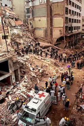 Firefighters and rescue workers search through the rubble of the Argentinian Israelite Mutual Association on July 18, 1994,  after a car bomb killed 85 people.