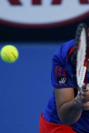Luksika Kumkhum hits a return to Petra Kvitova of the Czech Republic during their first-round match.