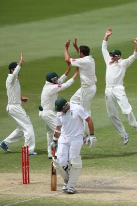 The prize: Australians rejoice as South African skipper Graeme Smith is dismissed.