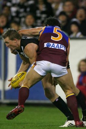 Nathan Buckley and Brad Scott tangle during their playing days.
