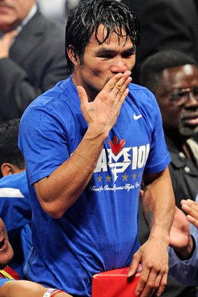 Manny Pacquiao acknowledges his fans after retaining his title.