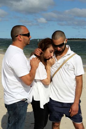 Distraught: Rouba Ksebe is consoled by her brother, Rabih Kahil, left, and elder son Aziz Ksebe.