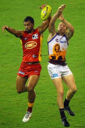 Hands up: Karmichael Hunt and Ryan Harwood in action.