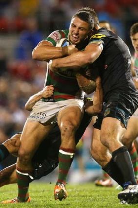 Sam Burgess of the Rabbitohs is tackled during the match against the Penrith Panthers on Friday.
