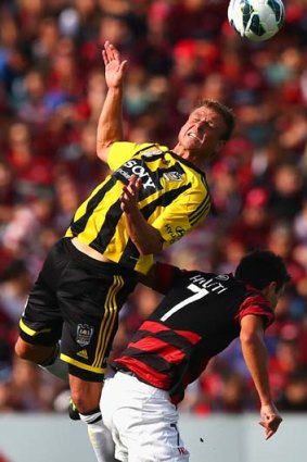 Tight tussle: Ben Sigmund of the Phoenix, left, competes for the ball against the Wanderers' Labinot Haliti.