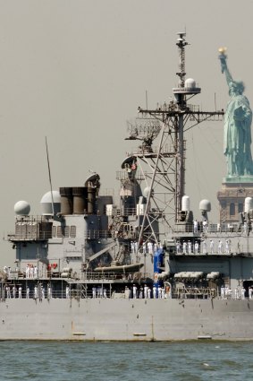 The USS Vella Gulf passes the Statue of Liberty. The new President shows an enthusiasm for military conflict.