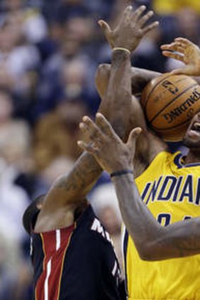 Indiana Pacers forward Paul George is trapped by Miami Heat forward LeBron James and guard Mario Chalmers.