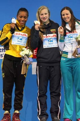 Gold medalist Ruta Meilutyte of Lithuania (centre), silver medalist Alia Atkinson of Jamaica (left) and bronze medalist Sarah Katsoulis of Australia during the women's 50 metres breaststroke awards ceremony of the FINA Short Course Swimming World Championships in Istanbul.