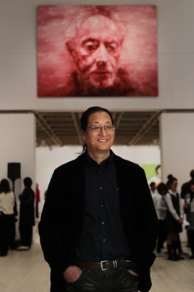 Red hand 0f courage ... Adam Chang in front of his prize-winning portrait of John Coetzee.