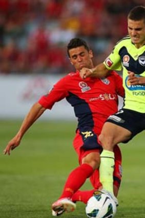 Ferreira v Ferreira: Adeiaide United's Fabio Ferreira tackles Diogo Ferreira of Melbourne Victory.