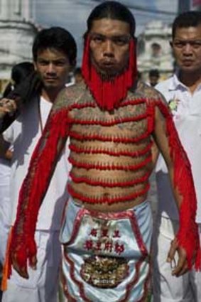 A devotee of the Chinese Bank Neow Shrine has his body decorated with hooked needles.