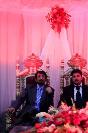 Ahmed Rashed Azimi sits on a throne next to his father at a male-only party. Women celebrated at a separate event.