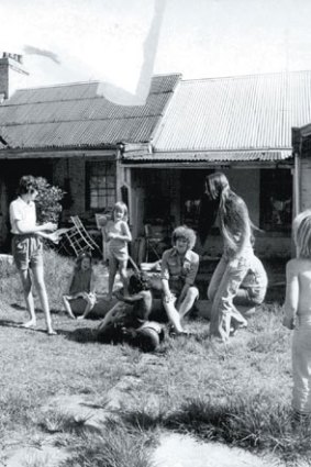 Women and children play in Elsie's backyard.