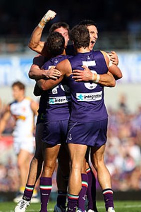 Matthew Pavlich celebrates a goal with his Dockers teammates.