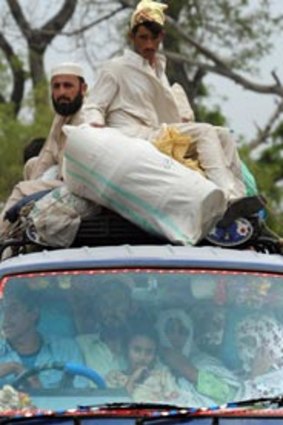 On th move... refugees from the Swat Valley head for Swabi, a relative safety.