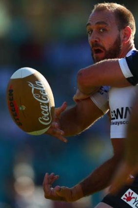 Eye on the ball: Jason Nightingale of the Dragons gets a pass away against the Wests Tigers.