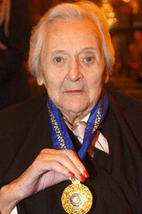 Nancy Wake displays her medal after she was made a Companion of the Order of Australia in London.