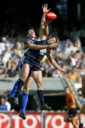 Flying high: Ian Prendergast (front) takes on North Melbourne's Corey McKernan during his time with Carlton.