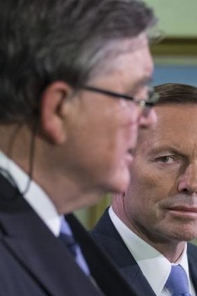 PM Tony Abbott watches as ASIO chief David Irvine explains the increase in terror threat level. 