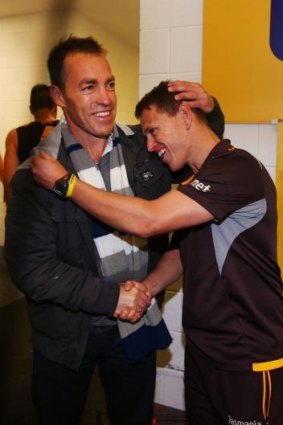 Alastair Clarkson, who is recovering from illness, hugs his stand-in Brendon Bolton, after the Hawks recorded their ninth win of the season last weekend.