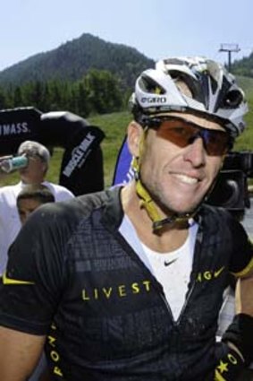 Lance Armstrong talks to the media after completing the Power of Four Mountain Bike Race on Aspen Mountain.