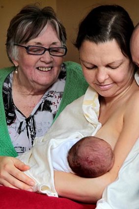 Midwife Jan Ireland, left, with clients Petra Betschart and Stuart Vickers, and three-day-old Louie.