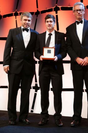 Jamie Warren, left, and FFA CEO David Gallop, right, present Marco Rojas of the Victory with the Johnny Warren Medal as the Hyundai A-League Player of the Year.