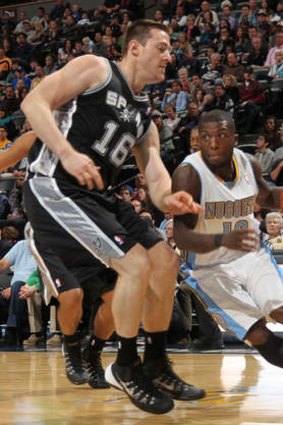 San Antonio's Aron Baynes guards Denver Nuggets guard Nate Robinson in their NBA pre-season clash at Denver on Monday.