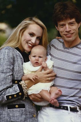 Jerry Hall and Mick Jagger with one of their four children, circa 1990.