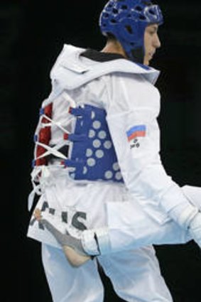 Too good ... Russia's Alexey Denisenko (blue) on his way to bronze against Australia's Safwan Khalil.