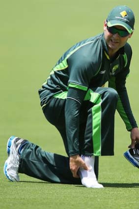 Michael Clarke inspects his ankle on Monday.