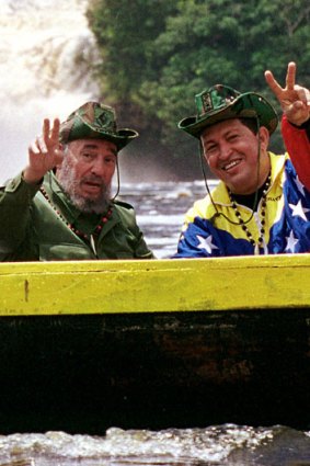 Cuba's President Fidel Castro, left, and Venezuela's President Hugo Chavez wave to a crowd while touring Canaima National Park in eastern Venezuela in a canoe.