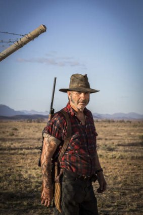 John Jarratt as Mick Taylor.