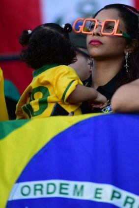 A Brazilian fan watches a live screening of her team's match against Croatia at the Fans Fest in Cuiaba, Brazil.