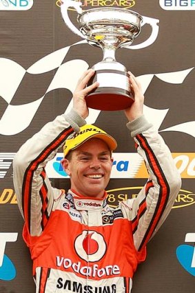 Cheers &#8230; Craig Lowndes shows the spoils of victory in race one on Saturday.